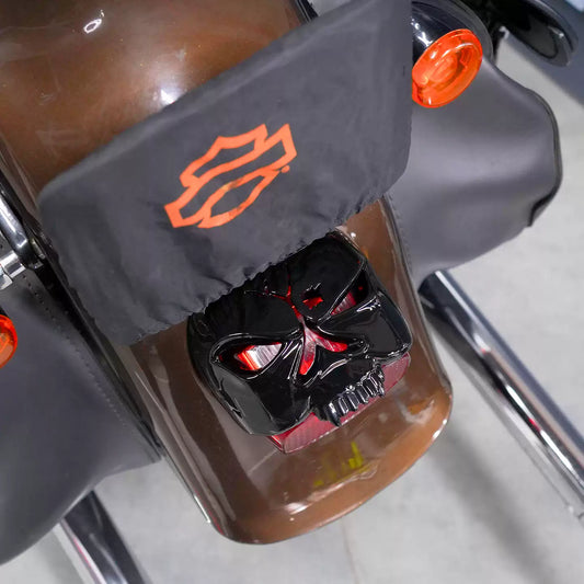 Black skull tail light cover installed on a Harley-Davidson rear light