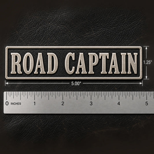 Large 5 by 1.25 inch officer-title name bar with comfortable letter spacing beside a precise metal ruler on leather, showing custom motorcycle club name bar patch options.