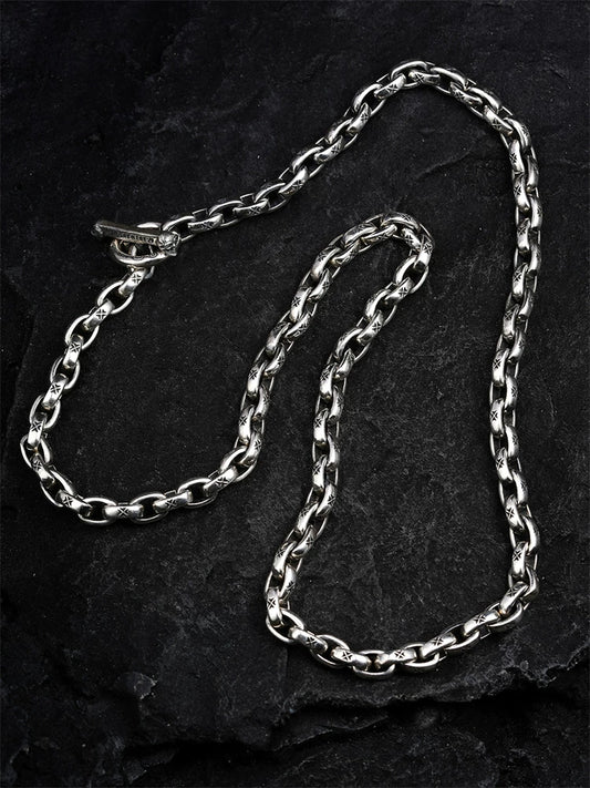 Maltese cross link sterling silver biker necklace laid flat on black stone