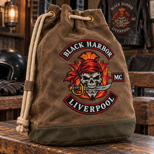 Waxed-brown heavy canvas motorcycle club drawstring bag with an oval reinforced base and natural rope.
