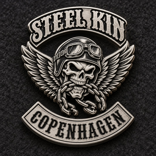 STEEL KIN sculpted pin in low-glare matte silver on dark felt.