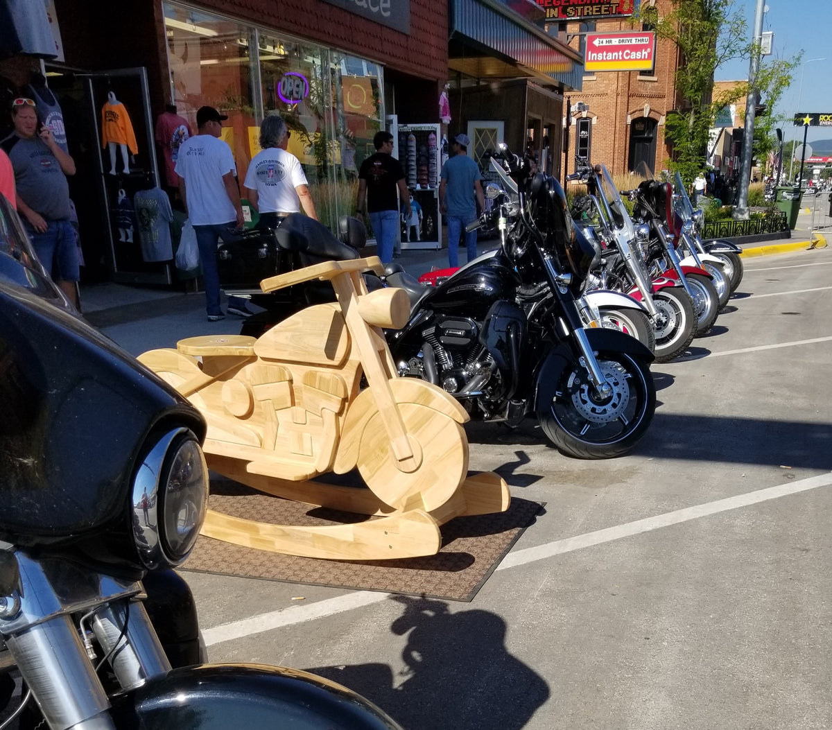 Archive view of a wooden custom motorcycle display on Main Street during the 2019 Sturgis rally