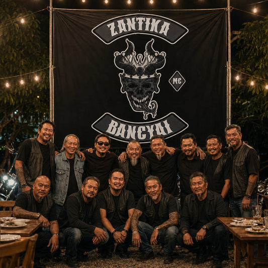 Founding and newer members posing with a custom motorcycle club anniversary banner.