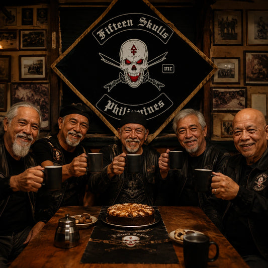 Founding motorcycle club members celebrate an anniversary with their custom diamond flag displayed behind the table.