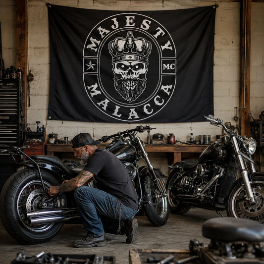 Classic custom swallowtail flag displayed above V-twin motorcycles in a private club garage.