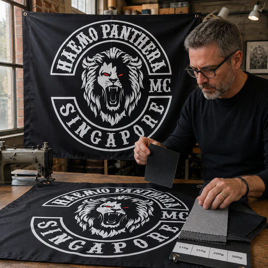 Motorcycle club members use a custom rectangular flag for material selection in a realistic American V-twin setting.