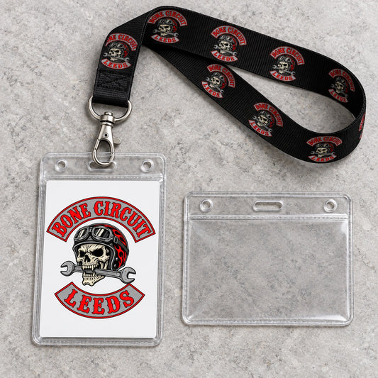 Portrait and landscape badge holders displayed beside a Bone Circuit club lanyard.