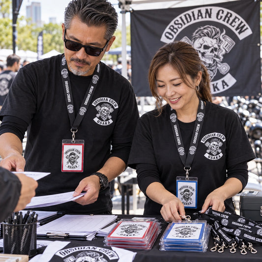 Event organizers wearing coordinated motorcycle club lanyards with distinct credential border colors.