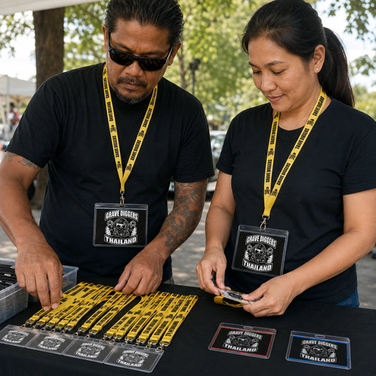 Event organizers wearing coordinated motorcycle club lanyards with distinct credential border colors.
