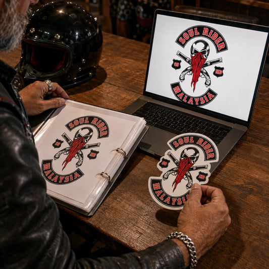 Club secretary comparing authorized club artwork with a matching custom sticker proof on a clubhouse table.