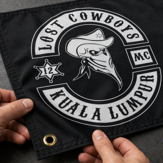 Motorcycle club members use a custom rectangular flag for club logo customization in a realistic American V-twin setting.