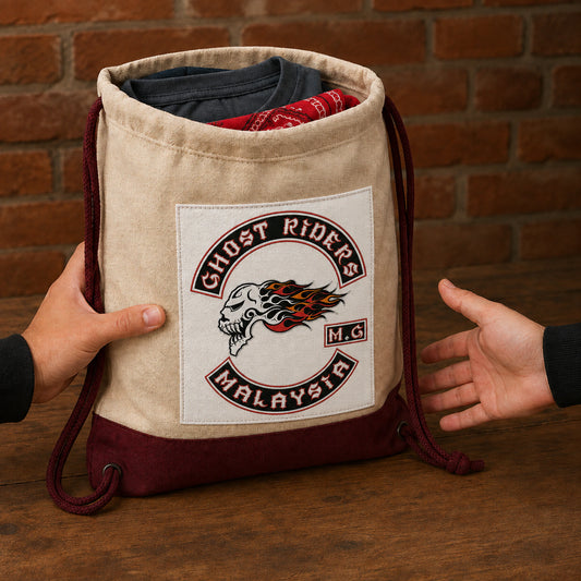 A motorcycle club membership officer presents a custom drawstring welcome pack to a new supporter.