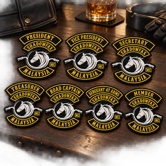 Coordinated officer title patches shown for a custom motorcycle club patch system in clubhouse table.