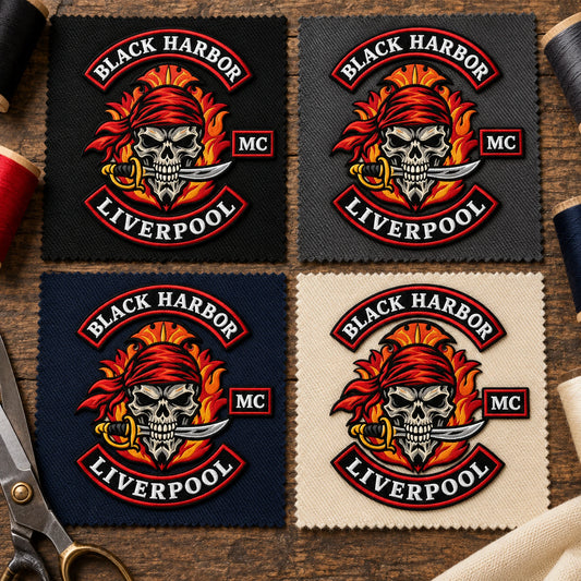 Black charcoal navy and cream twill patch bases for a motorcycle club, shown at fabric swatch table.