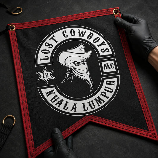 Motorcycle club quality inspector checking the print, stitching and hardware on a premium custom swallowtail flag.
