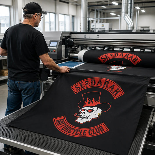 A textile operator starts production of custom motorcycle club square flags on professional equipment.