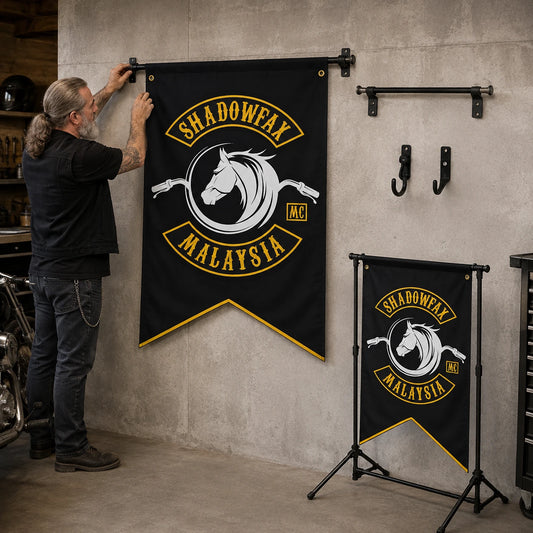 Motorcycle club member comparing wall, pole and event-stand hanging options for a custom swallowtail flag.