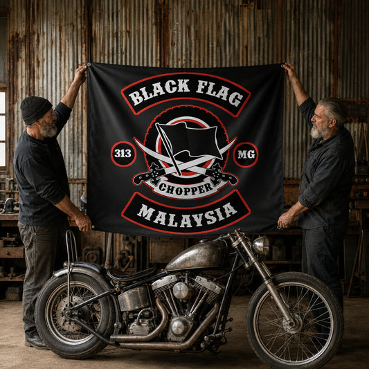 Custom bike builders displaying a vintage-style motorcycle club banner in an old workshop.