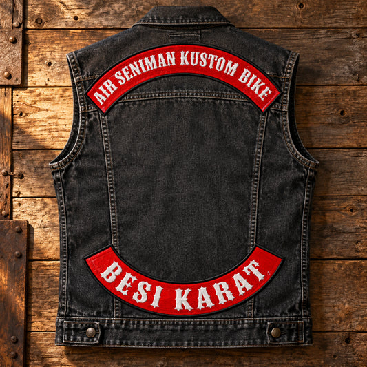 Complete charcoal denim motorcycle vest displaying Western lettering on custom top and bottom rocker patches.