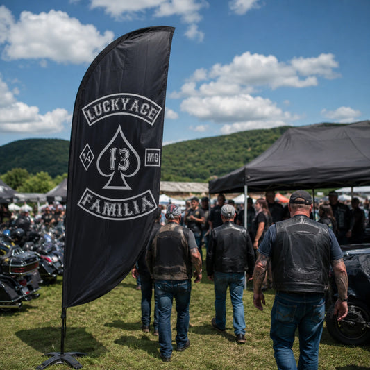 Motorcycle Rallies: custom motorcycle club feather flag shown in chapter welcome tent at a crowded regional rally with touring riders arriving.