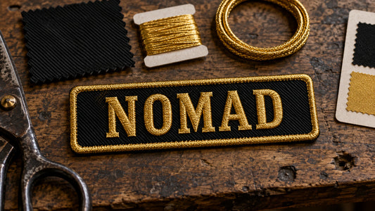 Close-up of a coordinated family of name-bar patches only, with different wording but visibly matched thread palette, background, border weight, lettering style and craftsmanship, showing custom motorcycle club name bar patch options.