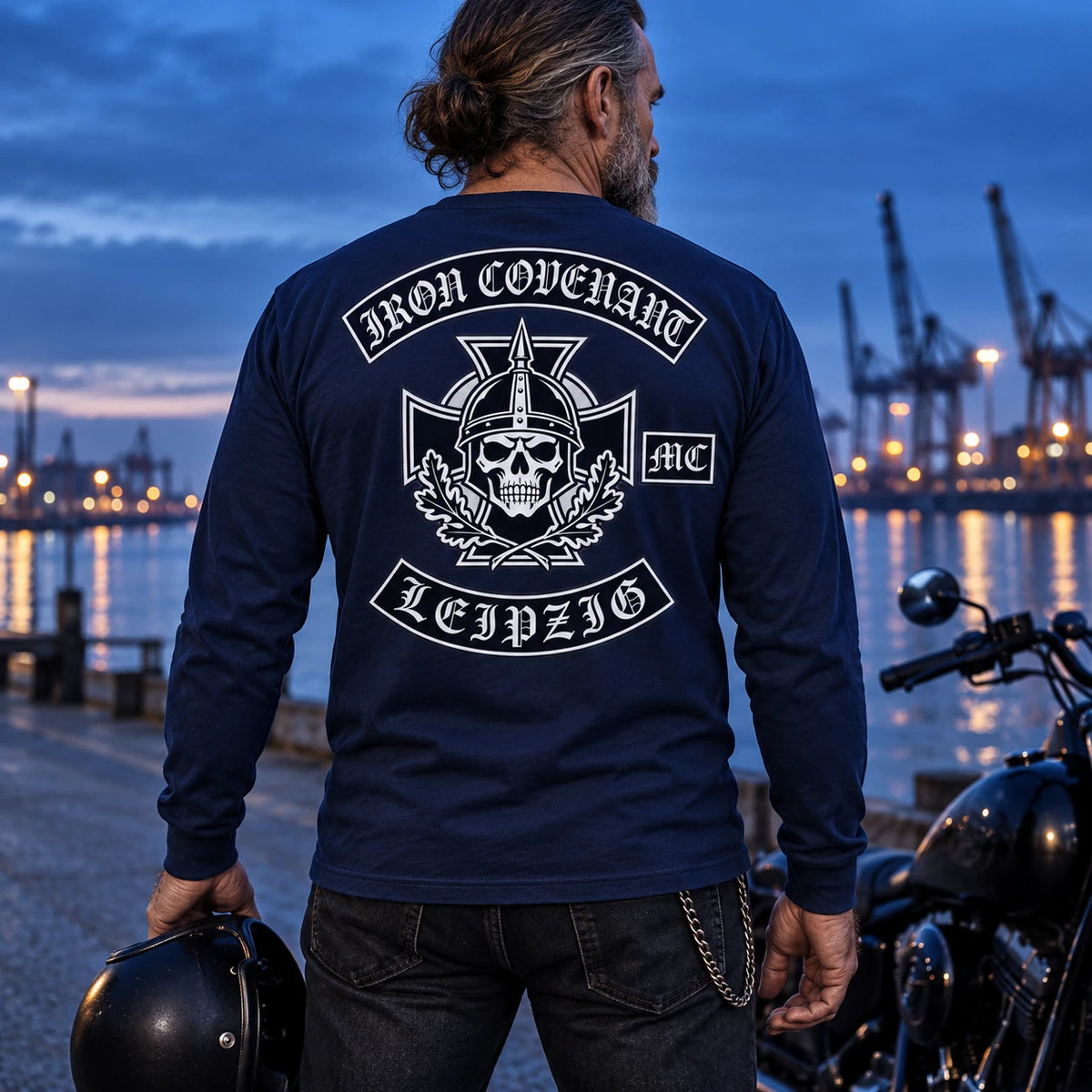 Deep navy motorcycle club long-sleeve shirt photographed at a harbor during blue hour.