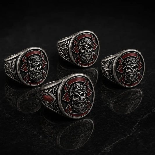 Four coordinated antique silver motorcycle club rings with matching bearded skull emblems and different engraved side-panel designs.