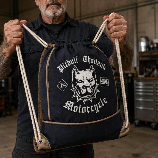 Premium reinforced motorcycle club drawstring backpack displayed in an industrial clubhouse.