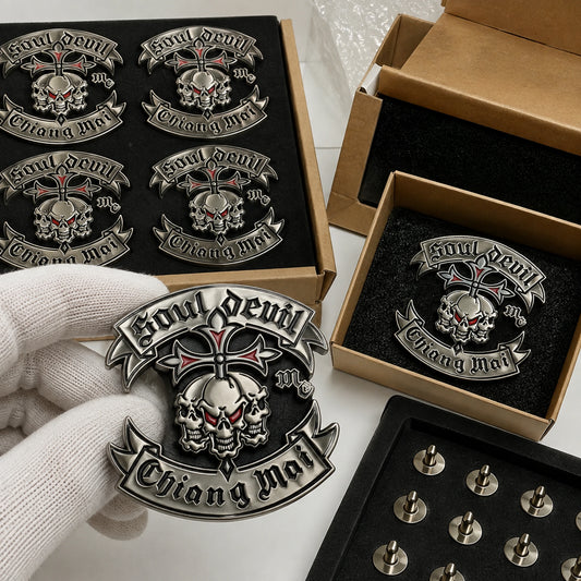 Polished silver 3D club pins of one approved identity being inspected and packed for worldwide shipping.