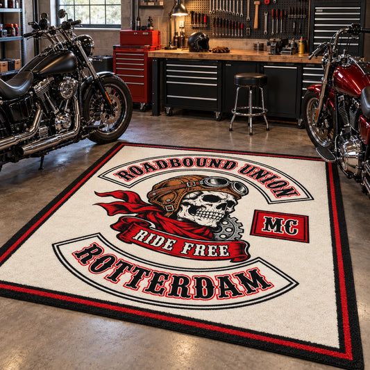 A custom motorcycle club rug sits beside American V-twin motorcycles in a workshop.