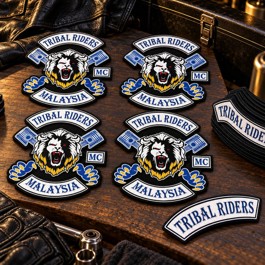 One replacement patch beside full chapter sets shown for a custom motorcycle club patch system in organized warehouse table.
