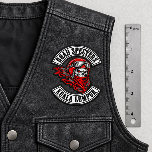 2.25-inch compact initials patch beside ruler for a motorcycle club, shown at measured leather vest front.