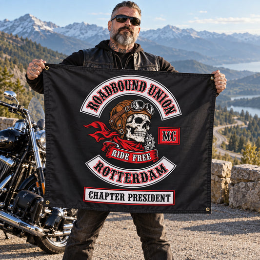 Chapter president displaying a personalized motorcycle club exchange flag at a mountain turnout.