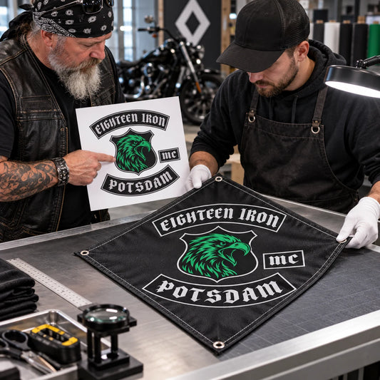 A rider and artisan compare the authorized club logo with its clean reproduction on custom diamond flag fabric.