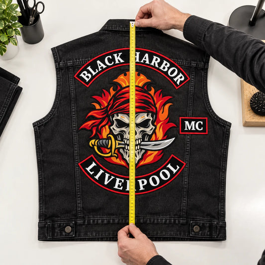 Usable back height measured vertically on a denim motorcycle vest from collar zone to lower edge.