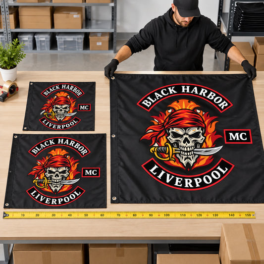 Small, medium and large custom motorcycle club exchange flags arranged for size comparison.