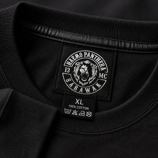 Close view of a custom motorcycle club neck label inside a premium long-sleeve shirt.
