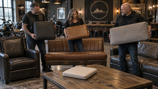 Mature motorcycle club volunteers compare cushion sizes against existing clubhouse seating and an insert.