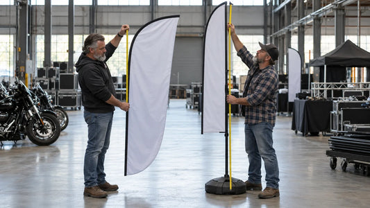 Two mature motorcycle club organizers compare feather-flag fabric height with total assembled pole height.
