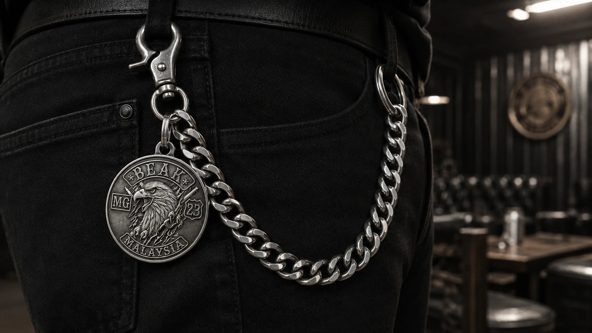 Heavy custom biker pants chain worn with black denim featuring an authorized motorcycle club logo.