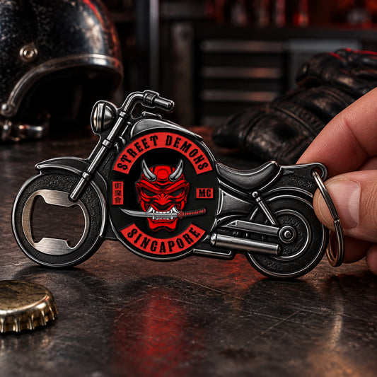 Solid motorcycle-shaped club bottle opener with approved club artwork and a functional opening mouth.