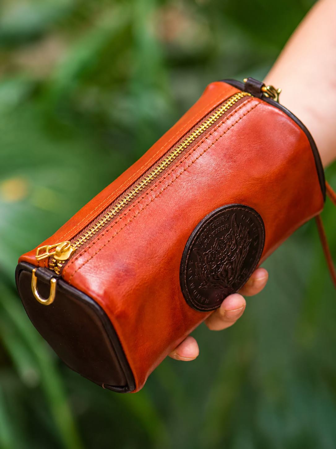 reddish brown dragon emblem top-grain leather biker wristlet wallet held in hand
