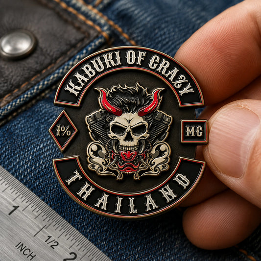 One-and-a-quarter-inch bronze club pin measured on a denim and leather vest fitting table.