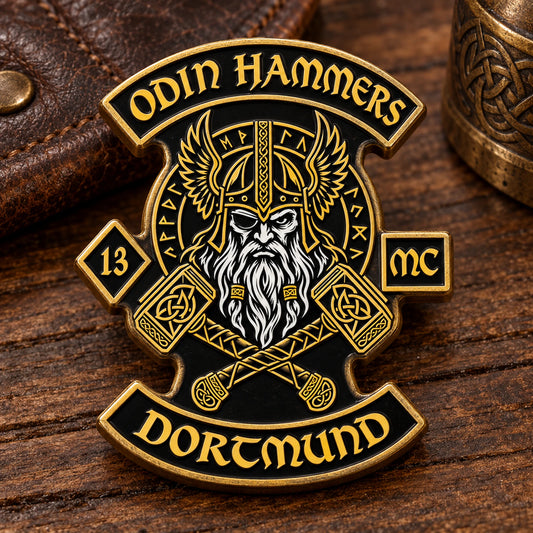 Odin Hammers Dortmund enamel pin with warm aged antique-brass metal on a heritage workbench.