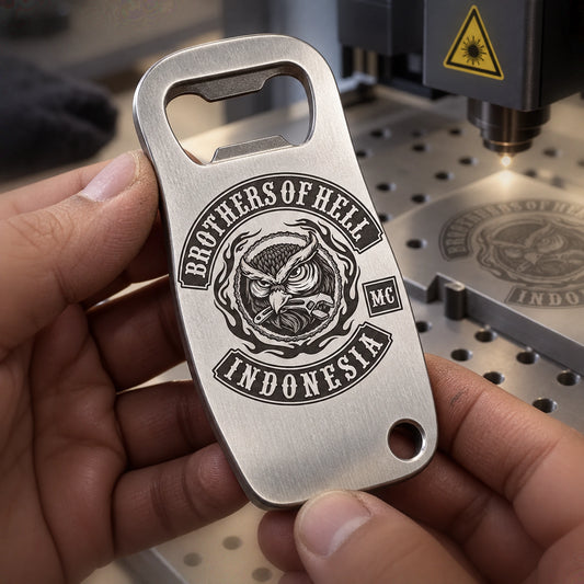 Solid motorcycle club bottle opener receiving precise laser engraving.