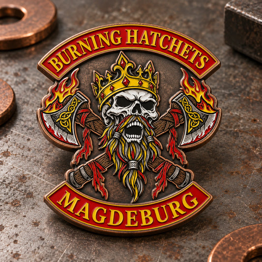 Burning Hatchets Magdeburg enamel pin with aged antique-copper borders on an industrial workbench.