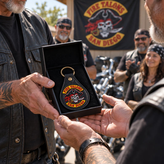 New motorcycle club member receiving a personalized leather keychain with an authorized club emblem.