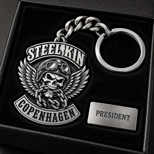 Premium sterling silver motorcycle club officer keychain with deep monochrome relief in a presentation box.