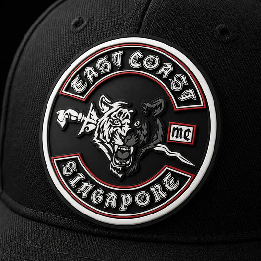 Durable molded PVC motorcycle club logo patch on a black performance cap.