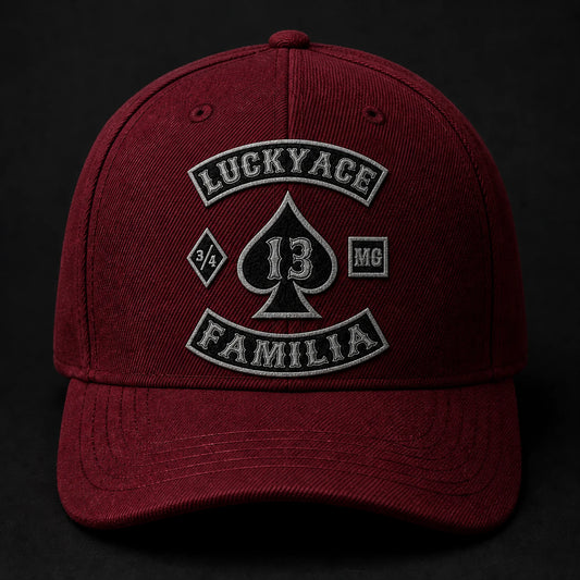 Textured chenille motorcycle club logo element applied to a burgundy custom cap.